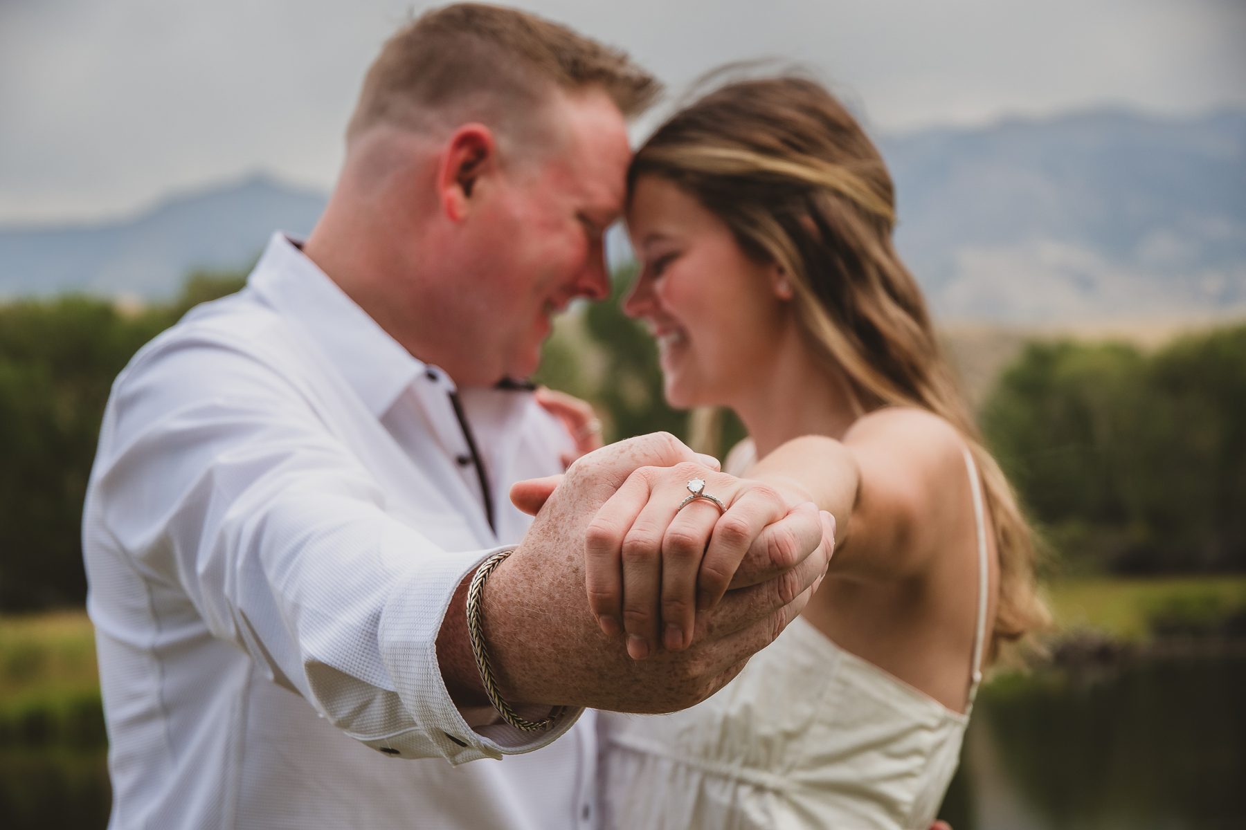 Mariah and Gabe forehead to forehead, showing the ring